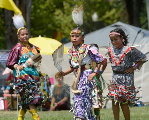 Al Hartmann  |  The Salt Lake Tribune 
Teen "Jingle" dancers compete at the annual Native American Celebration at Liberty Park July 25.   Jingle Dresses are decorated with rolled up snuff can lids hung with ribbon.  Ribbons are sewn to the dress and placed close enough so they can hit together making a beautiful sound.