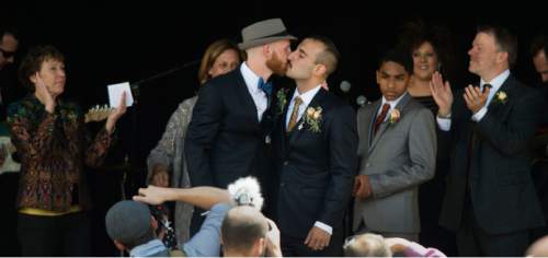 Steve Griffin  |  The Salt Lake Tribune
Derek Kitchen and Moudi Sbeity, the lead plaintiffs from the landmark Utah case that legalized same-sex marriage, kiss after being announced as husband and husband by friend and minister Nan Seymour during their public marriage ceremony at the Gallivan Center Plaza in Salt Lake City, Sunday, May 24, 2015.