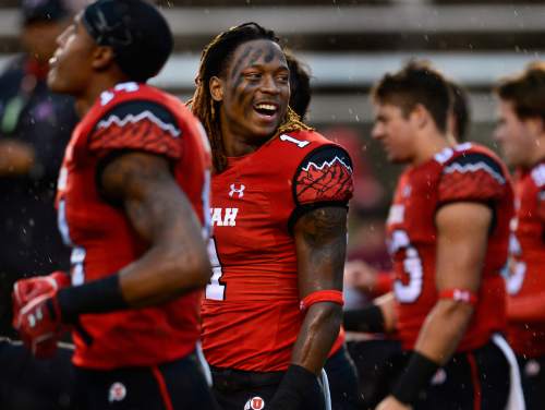 Scott Sommerdorf   |  The Salt Lake Tribune
Utah DB Boobie Hobbs laughs with team mates as he and other players stretch in a steady rain prior to facing off against Washington State, Saturday, September 27, 2014.