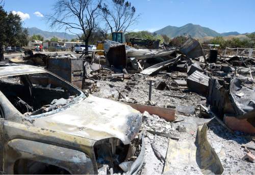 Al Hartmann  |  The Salt Lake Tribune 
Officials suspect arson destroyed 10 homes and other property in a neighborhood in Tooele, Utah, on Wednesday, July 20, 2016.