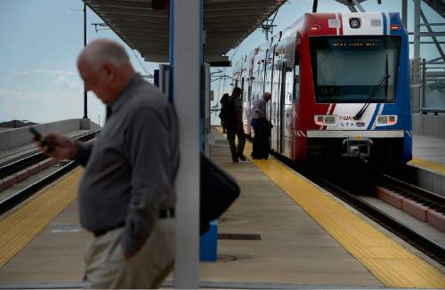 Scott Sommerdorf   |  Tribune file photo
Riders board a UTA TRAX train on North Temple that's headed toward the airport, Thursday, June 11, 2015.