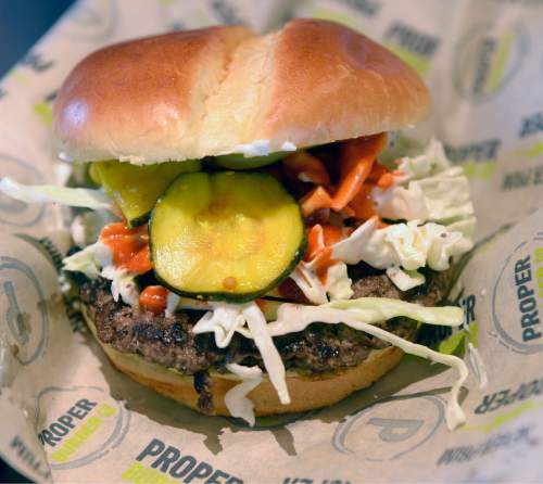 Al Hartmann  |  The Salt Lake Tribune 
Fiery Furnace Burger with sriracha buffalo sauce, blue cheese spread. coleslaw and zucchini pickles at Proper Burger Co. in Salt Lake City.