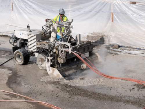 Rick Egan  |  The Salt Lake Tribune

Todd Brown uses a hydro demolition machine on a bridge deck on I-215. The new technique uses high pressure water jets to demolish concrete bridge decks without damaging the reinforcing steel or structure underneath. Friday, July 29, 2016.