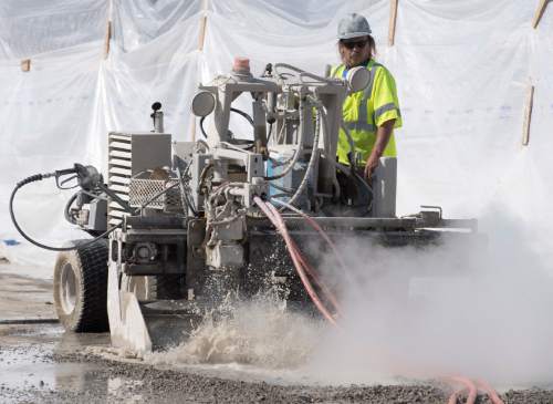 Rick Egan  |  The Salt Lake Tribune

Todd Brown uses a hydro demolition machine on a bridge deck on I-215. The new technique uses high-pressure water jets to demolish concrete bridge decks without damaging the reinforcing steel or structure underneath. Friday, July 29, 2016.