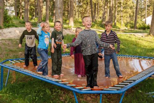 Trent Nelson  |  The Salt Lake Tribune
Children of polygamist Winston Blackmore combine water and a trampoline for an afternoon activity in Bountiful British Columbia, 2006.