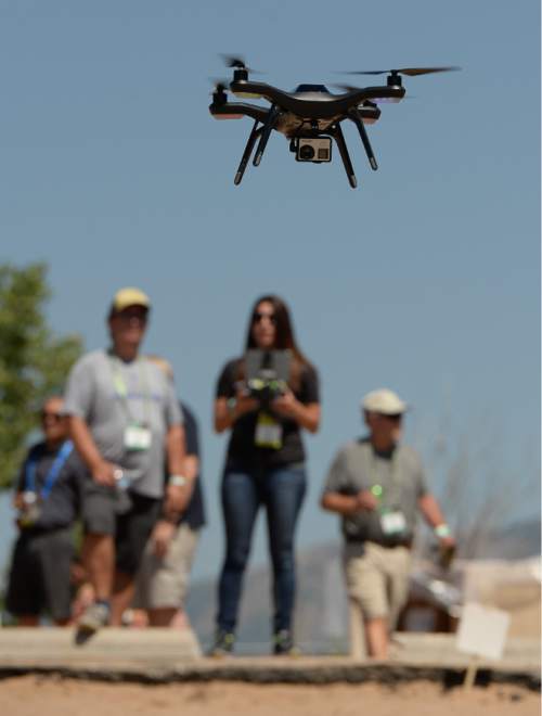 Francisco Kjolseth | The Salt Lake Tribune
Tabitha Galeana hovers the Solo Drone by 3DR Robotics out of Austin, TX, during the Outdoor Retailer Summer Market kickoff  demo day at Pineview Reservoir's Cemetery Point in Huntsville on Tuesday, Aug. 4, 2015. Many of the manufacturers who will be at Summer Market use the opportunity to let retailers try their products, from paddle boards, canoes, kayaks and other water recreation gear.