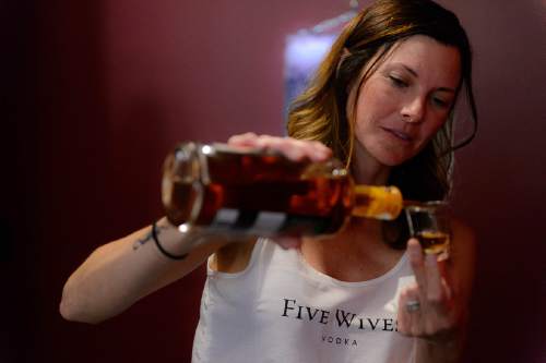 Trent Nelson  |  The Salt Lake Tribune
Brooke Wadman pours a sample of the new Porter's Peach Liqueur, blend of peach and whiskey, at Ogden's Own Distillery in Ogden, Friday July 15, 2016. Utah distilleries must now have a Zion Curtain, to keep minors from seeing adults taste; distilleries also must offer "substantial food" to tasters who may want it.