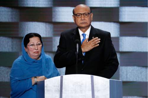 FILE - In this Thursday, July 28, 2016 file photo, Khizr Khan, father of fallen US Army Capt. Humayun S. M. Khan and his wife Ghazala speak during the final day of the Democratic National Convention in Philadelphia. Republican presidential nominee Donald Trump broke a major American political and societal taboo over the weekend when he engaged in an emotionally-charged feud with Khizr and Ghazala Khan, the bereaved parents of a decorated Muslim Army captain killed by a suicide bomber in Iraq. He further stoked outrage by implying Ghazala Khan did not speak while standing alongside her husband at last week's Democratic convention because they are Muslim. (AP Photo/J. Scott Applewhite, File)