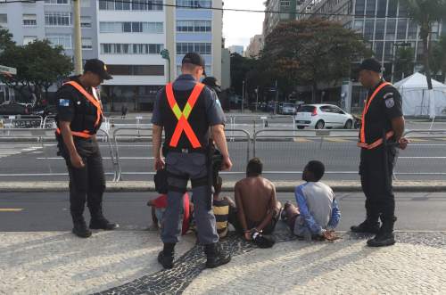 Christopher Kamrani | Salt Lake Tribune
Brazilian security members surround a group of four young boys on the famed sidewalk of Copacabana Beach on Aug. 4, 2016. The two older boys to the right sat in handcuffs.