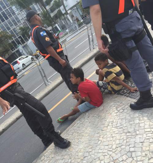 Christopher Kamrani | Salt Lake Tribune
Two young boys sit on the sidewalk at Copacabana Beach surrounded by four Brazilian security officers Aug. 4, 2016.