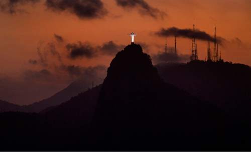 Rick Egan  |  The Salt Lake Tribune

The sun sets behind Christ The Redeemer, on top of Corcovado Mountain, in Tijuca National Park, in Rio de Janeiro.  The statue is 98 feet tall, not including its 26 ft pedestal, and its arms stretch 92 ft wide. Thursday, August 4, 2016.
