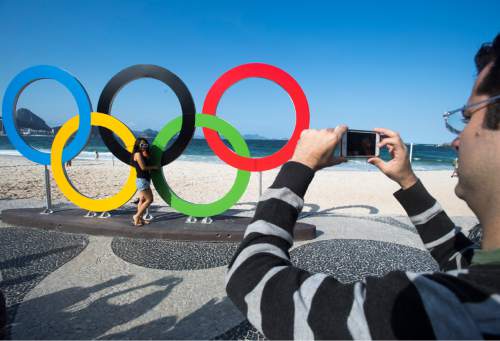 Rick Egan  |  The Salt Lake Tribune

Fabio Campos snaps a picture of Ha Nguyen in front of the Olympic rings on Copacabana beach, in Rio de Janeiro, Thursday, August 4, 2016.