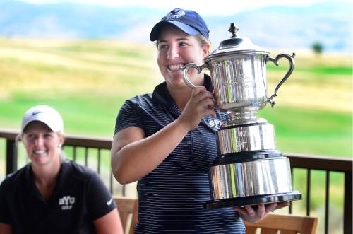 Scott Sommerdorf   |  The Salt Lake Tribune  
Kendra Dalton holds the Utah Women's State Amateur golf tournament trophy after her win at the 2016 Utah Women's State Amateur golf tournament over Lea Garner - both of BYU - at Victory Ranch Golf Club in Francis, Friday, August 5, 2016.