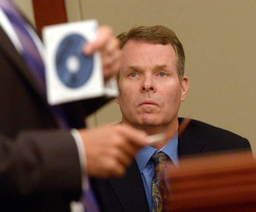 Al Hartmann  |  The Salt Lake Tribune 
Former Utah Attoney General John Swallow charged with more than a dozen bribery and public-corruption counts watches as his defense lawyer Scott Williams argues before Judge Elizabeth Hruby-Mills in 3rd Distirct Court Wednesday July 13.  Williams argued that the prosecution investigation withheld documents on DVD's that are tainted and contain privileged attorney-client information that the prosecution could have seen. He is asking the judge to dismiss the case.