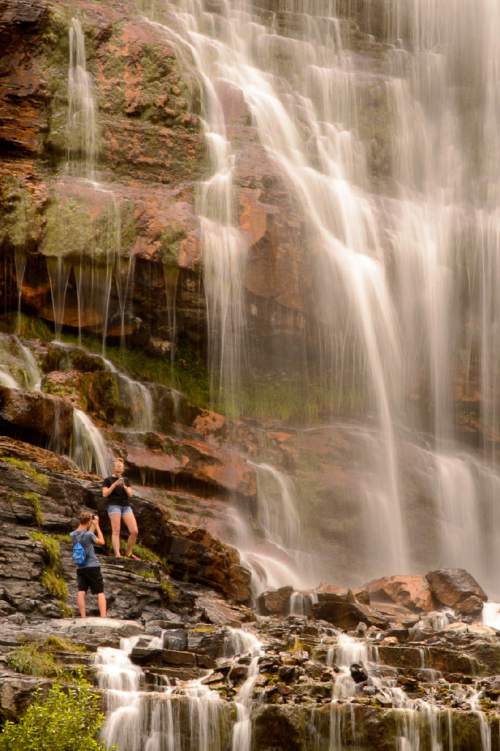 Trent Nelson  |  The Salt Lake Tribune
Hikers cool off at Bridal Veil Falls in Provo on Friday.