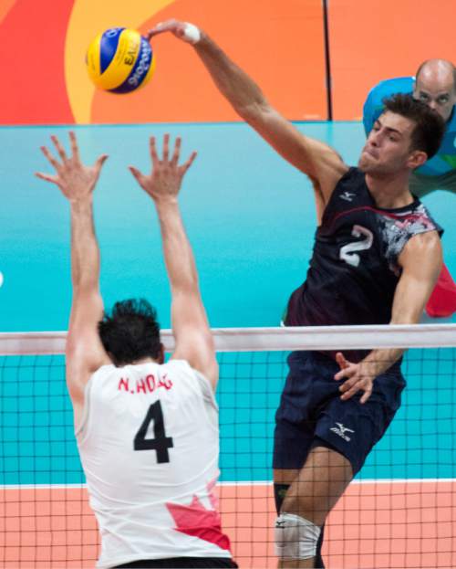 Rick Egan  |  The Salt Lake Tribune

Aaron Russell (2) of United States hits the ball over Nicholas Hoag (4) of Canada, in Men's Olympic volleyball action at Ginásio do Maracanãzinho, in Rio de Janeiro, Sunday, August 7, 2016.