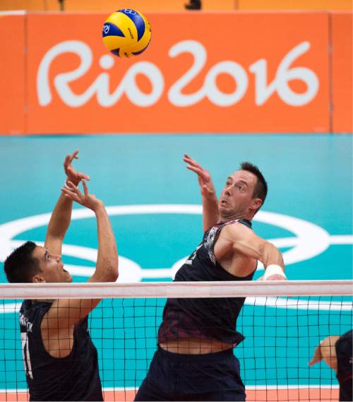 Rick Egan  |  The Salt Lake Tribune

Micah Christenson (11) sets the ball for David Lee (4) of United States in Men's Olympic volleyball action at Ginásio do Maracanãzinho, in Rio de Janeiro, Sunday, August 7, 2016.