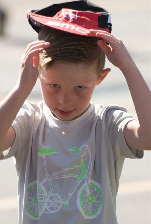 Leah Hogsten  |  The Salt Lake Tribune
Trey Galbraith, 5, tries on his new BMC Racing cap at the start of Stage 6 of the Tour of Utah on Saturday, August 6, 2016 that took cyclists on a 114-mile ride with over 11,000 feet of climbing from Snowbasin Ski Resort to Snowbird.