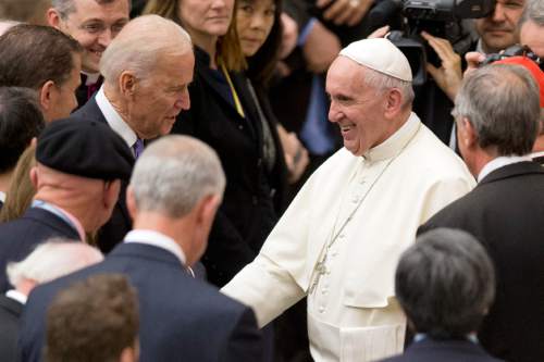 Pope Francis shakes hands with US vice president Joe Biden as he takes part at a congress on the progress of regenerative medicine and its cultural impact, being held in the Pope Paul VI hall at the Vatican,  Friday, April 29, 2016. (AP Photo/Andrew Medichini)