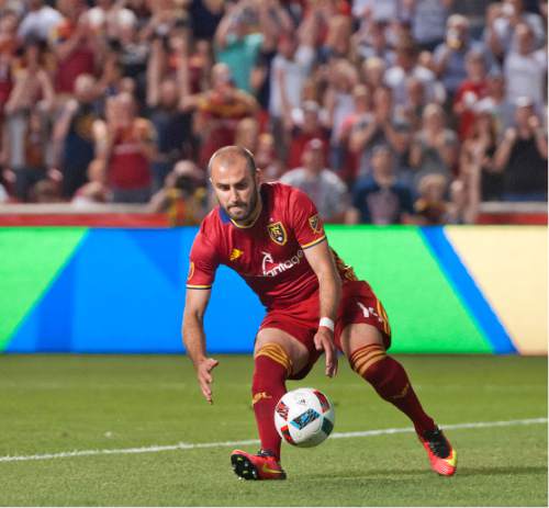 Michael Mangum  |  Special to the Tribune

Real Salt Lake forward Yura Movsisyan (14) quickly picks up the ball to run to midfield to reset play following his penalty kick score during their MLS match against the Montreal Impact at Rio Tinto Stadium in Sandy, UT on Saturday, July 9th, 2016. The match ended in a 1-1 draw.