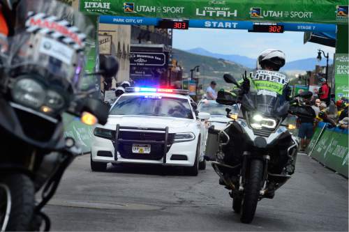 Scott Sommerdorf   |  The Salt Lake Tribune  
One of the many UHP cars involved with the Tour of Utah cruises through the start on Park City's Main Street, Sunday, August 7, 2016.
