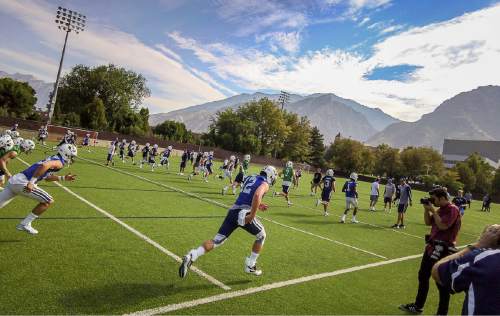 Trent Nelson  |  The Salt Lake Tribune
Players warm up at the first BYU fall camp practice under new coach Kalani Sitake, Friday August 5, 2016 in Provo.