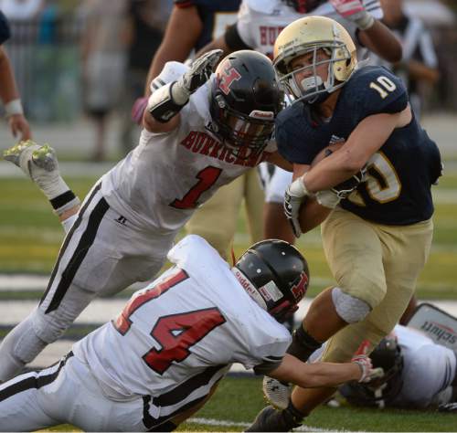 Francisco Kjolseth | The Salt Lake Tribune
Seth Kaelin of Skyline tries to push through the Hurricane defense in game action at Skyline on Thursday, Aug. 20, 2015.