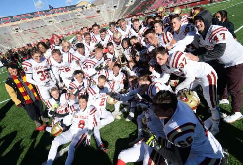 Steve Griffin  |  The Salt Lake Tribune

Logan players hold the championship trophy as they huddle up for a photo after defeating Dixie in  the Class 3AA state football championship game at Rice-Eccles Stadium in Salt Lake City, Friday, November 20, 2015.  Logan defeated Dixie to win the championship.