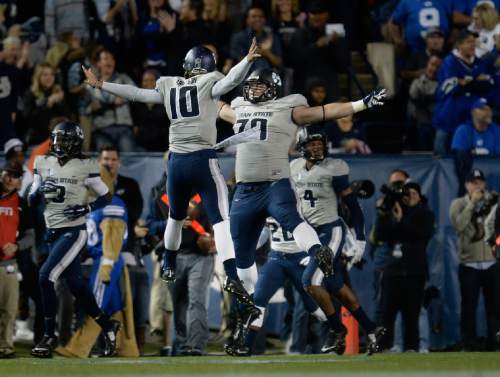 Scott Sommerdorf  |  The Salt Lake Tribune
Utah State Aggies quarterback Darell Garretson celebrates with Utah State Aggies guard Travis Seefeldt after a TD pass during first half play. Utah State led BYU 28-14 at the half in Provo, Friday, October 1, 2014.
