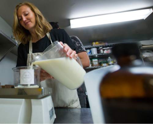 Steve Griffin | The Salt Lake Tribune

Jolene Hale, owner of Milk Honey Fine Yogurt, fills containers with yogurt as she makes and bottles her homemade yogurt to sell at the  Downtown Farmers Market. She bottles the yogurt at Enlightened Bakery in Provo.