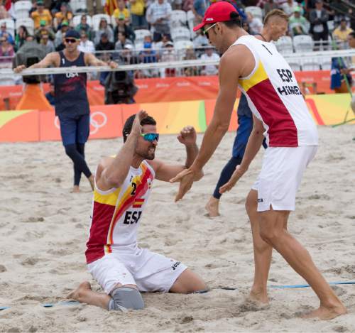 Rick Egan  |  The Salt Lake Tribune

Jacob Gibb (1) of United States watches Adrian Gavira Collado (2) and Pablo Herrera Allepuz of Spain celebrate their win over United States, at the Beach Volleyball Arena, in Rio de Janeiro, Wednesday, August 10, 2016.