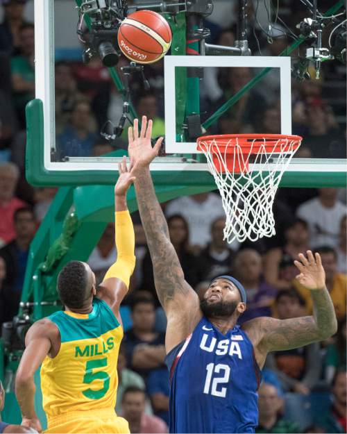 Rick Egan  |  The Salt Lake Tribune

Patty Mills (5) of Australia tosses the ball over the long arm of Demarcus Cousins (12) of United States for two points, in Olympic basketball action, USA vs. Australia, in Rio de Janeiro, Wednesday, August 10, 2016.
