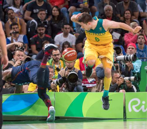 Rick Egan  |  The Salt Lake Tribune

Matthew Dellavedova (8) of Australia tries to avoid the ball, as Paul George (13) fallout of bounds after saving the ball for the United States, in Olympic basketball action, USA vs. Australia, in Rio de Janeiro, Wednesday, August 10, 2016.
