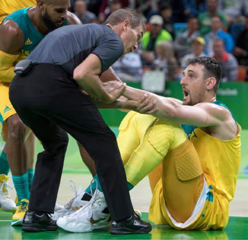 Rick Egan  |  The Salt Lake Tribune

Andrew Bogut (6) of Australia, has a few words for three official, as he helps him to his feet, after being knocked to the ground by Kevin Durant (5) of United States, in Olympic basketball action, USA vs. Australia,  in Rio de Janeiro, Wednesday, August 10, 2016.