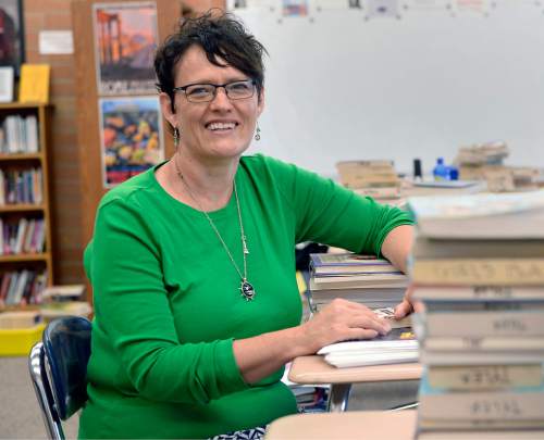 Al Hartmann  |  The Salt Lake Tribune 
Denée Tyler, an Alpine School District English teacher for seventh and eighth graders at Mountain Ridge Junior High School in Highland starts to organize books in her classroom Wednesday August 10 for the new school year.  She mentors younger teachers and says that the problem isn't attracting teachers, but retaining them. Tyler believes it will take a bump in base pay to fill a shortage of teachers in the Beehive State.