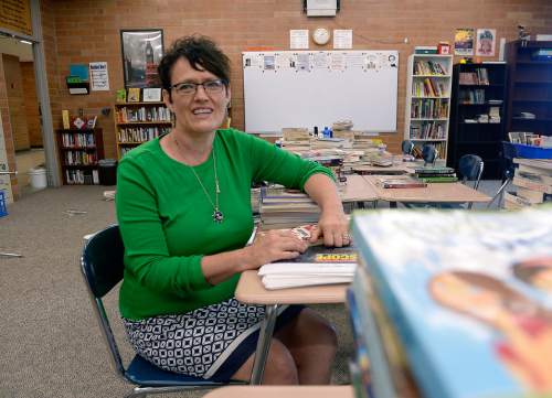 Al Hartmann  |  The Salt Lake Tribune 
Denée Tyler, an Alpine School District English teacher for seventh and eighth graders at Mountain Ridge Junior High School in Highland starts to organize books in her classroom Wednesday August 10 for the new school year.  She mentors younger teachers and says that the problem isn't attracting teachers, but retaining them. Tyler believes it will take a bump in base pay to fill a shortage of teachers in the Beehive State.