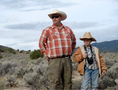 Al Hartmann  |  The Salt Lake Tribune 
Rancher Mark Wintch and his son Kody, 9,  watch the The BLM round up wild horses in Blawn Wash about 35 miles southwest of Milford Monday July 28.  He owns BLM grazing allotments in the area but has chosen not to graze his cattle this year due to drought-like conditions on the range.