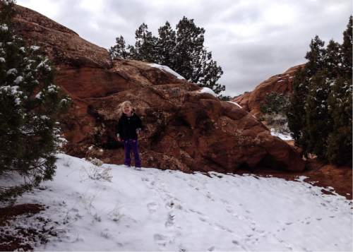 Erin Alberty  |  The Salt Lake Tribune

The author's daughter follows animal tracks in the snow Nov. 29, 2015 near the Devils Garden campground at Arches National Park.