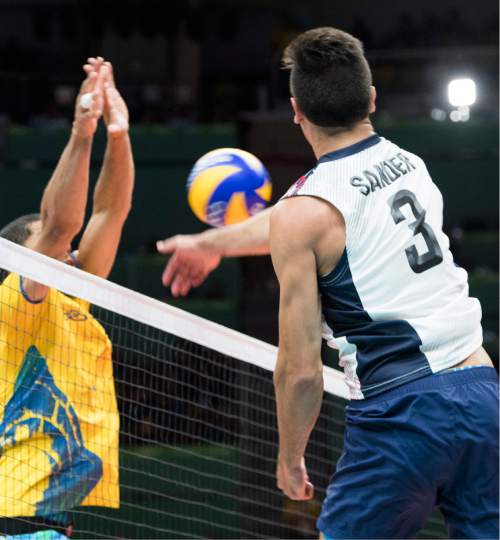 Rick Egan  |  The Salt Lake Tribune

Taylor Sander (3) of United States hits the ball past the defender from Brazil, in volleyball action USA vs. Brazil, in Rio de Janeiro, Thursday, August 11, 2016.