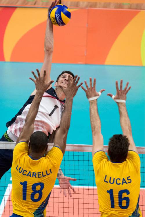 Rick Egan  |  The Salt Lake Tribune

Matthew Anderson (1) of United States hits the ball as Ricardo Lucarelli (18) Lucas Saatkamp (16) defend for Brazil, in volleyball action USA vs. Brazil, in Rio de Janeiro, Thursday, August 11, 2016.