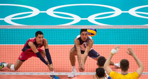 Rick Egan  |  The Salt Lake Tribune

Taylor Sander (3) of United States hits the ball as teammate Erik Shoji (22) assists on the left for the USA, in volleyball action USA vs. Brazil, in Rio de Janeiro, Thursday, August 11, 2016.