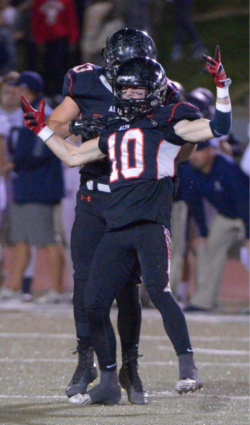 Leah Hogsten  |  The Salt Lake Tribune
Alta's London Rockwood celebrates his pass block  intended for Corner Canyon's Chase Meyer. 
Alta High School football team leads Corner Canyon High School 31-24, Friday, October 23, 2015 at Alta.