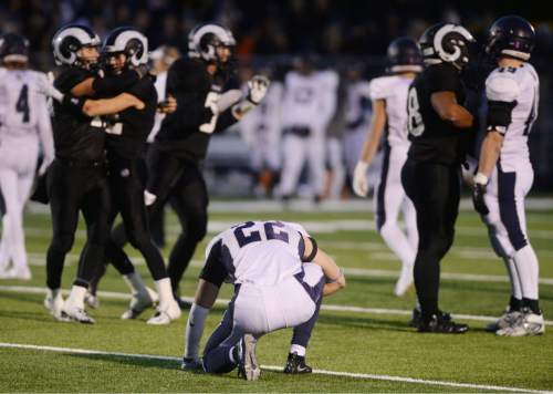 Steve Griffin  |  The Salt Lake Tribune

Corner Canyon's Perry Sandun, center falls to the ground in disbelief after Highland defeated Corner Canyon in an unbelievable double overtime victory at Highland High School in Salt Lake City, Friday, November 6, 2015.  Highland scored 21 points in the final 3 minutes of the game to tie Corner Canyon at 35 and went on to win in double overtime 41-38.