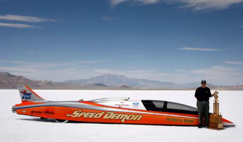 Rick Egan   |  Tribune file photo

George Poteet stands by his car "Speed Demon," along with the Hot Rod Magazine trophy, at the Bonneville Salt Flats, Thursday, August 18, 2011. The Speed Demon's top speed was 427 mph.