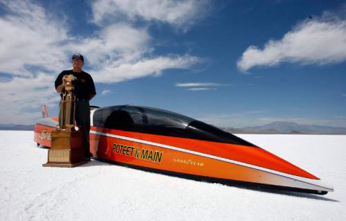 Rick Egan   |  Tribune file photo
George Poteet stands by his car "Speed Demon" along with the Hot Rod Magazine Trophy, at the Bonneville Salt Flats during the 2011 Speed Week. This year's Speed Week runs through Friday.