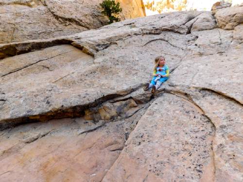 Erin Alberty  |  The Salt Lake Tribune

The authors daughter takes a quiet moment of rest on a massive wall of rock in Surprise Canyon on Oct. 4, 2015 in Capitol Reef National Park.