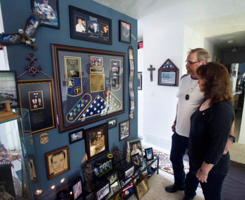 Steve Griffin / The Salt Lake Tribune

Keno and Sam Day look at a memorial for their son Jared Day in their Taylorsville, Utah home Monday August 1, 2016. On Aug. 6, 2011, Taliban fighters shot down a Chinook helicopter carrying 38 military personnel, including 31 Americans -- the largest loss of U.S. life in the Afghanistan campaign -- and two Utahns:  Jared Day and Blanding's Jason Workman.