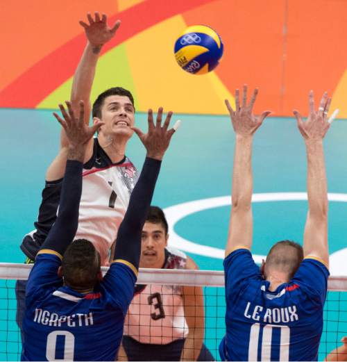 Rick Egan  |  The Salt Lake Tribune

Matthew Anderson (1) of United States hits the ball over Earvin Ngapeth (9) and Kevin le Roux (10) of France, in Olympic volleyball action at the Maracanãzinho Arena, in Rio de Janeiro Brazil, Saturday, August 13, 2016.