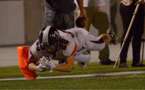 Leah Hogsten  |  The Salt Lake Tribune
Murray's Hunter Jones leaps into the end zone for a touchdown. Olympus High School leads Murray High School, 30-14 during their football game Friday, October 9, 2015 at Olympus High School.