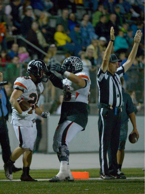 Leah Hogsten  |  The Salt Lake Tribune
Murray's Hunter Jones and Luke Shipley celebrate Jones' touchdown. Olympus High School leads Murray High School, 30-14 during their football game Friday, October 9, 2015 at Olympus High School.